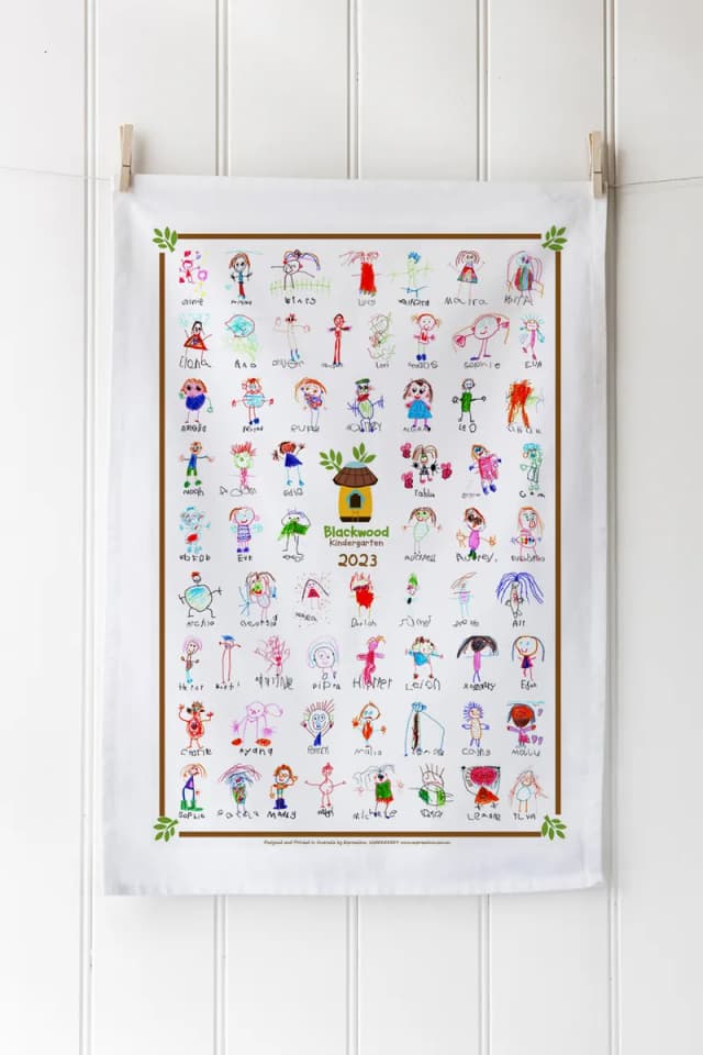 A tea towel digitally printed with children’s colour portraits