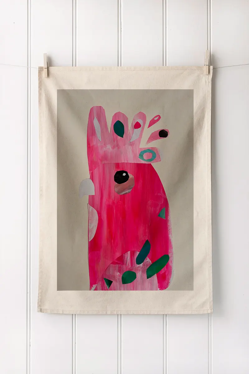 A tea towel printed with one child’s pink bird painting