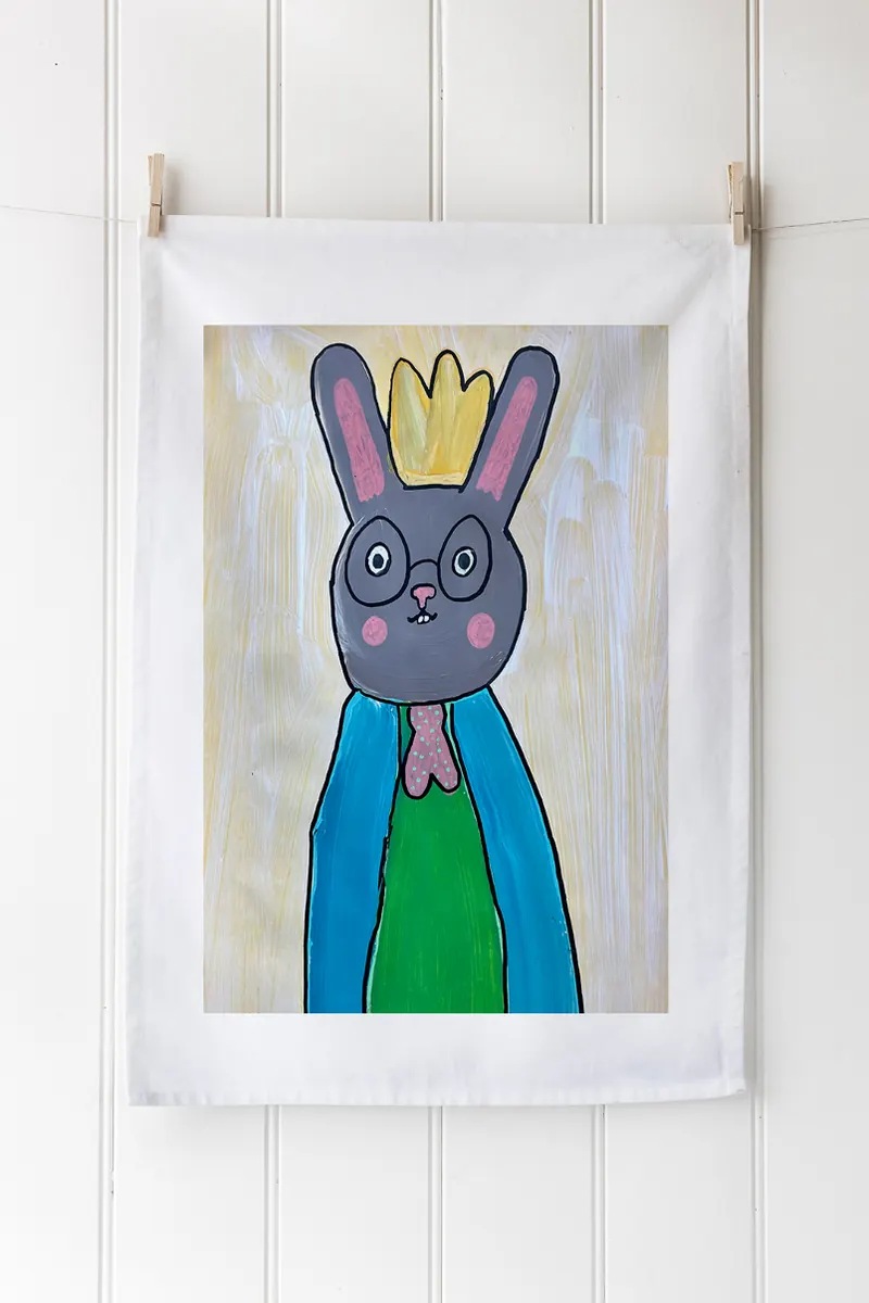 A tea towel printed with one child’s rabbit painting