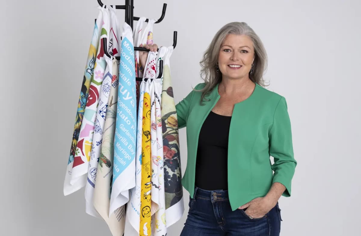 Expressions founder Emma McNeilly with a rack of printed tea towels